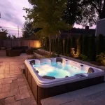 Backyard hot tub with electrical installation and patio lighting in Metro Vancouver.